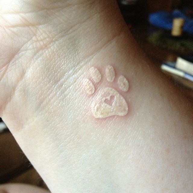 White dog paw tattoo