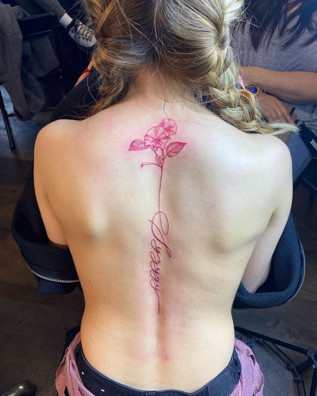 Red ink Spine Tattoo