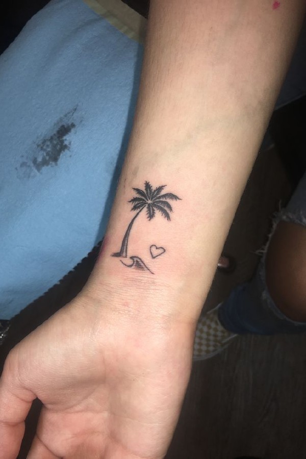 Small tattoo of a palm tree