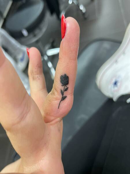 Black Rose Finger Tattoo