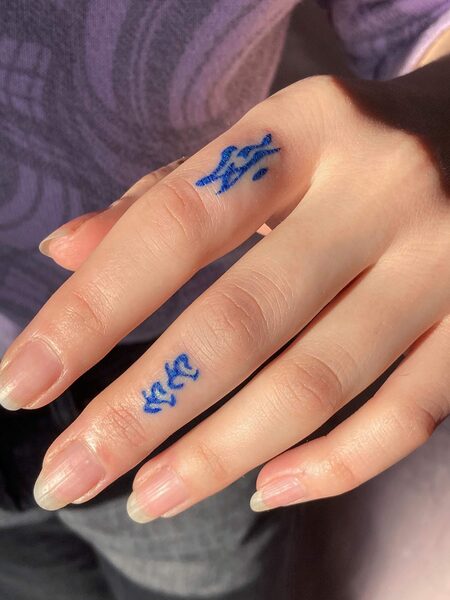 Blue Finger Tattoo