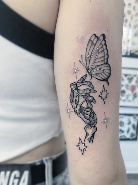 Butterfly and Skeleton Hand Tattoo