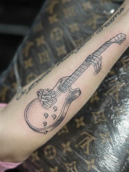 Guitar And Skeleton Hand Tattoo