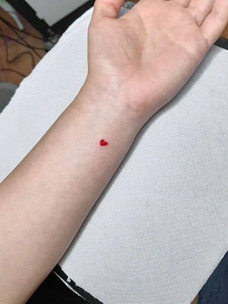 Minimalist Red Heart Tattoo