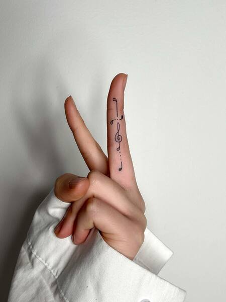 Music Note Finger Tattoo