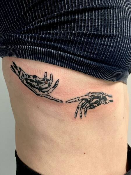 Skeleton Hand Tattoo on Rib