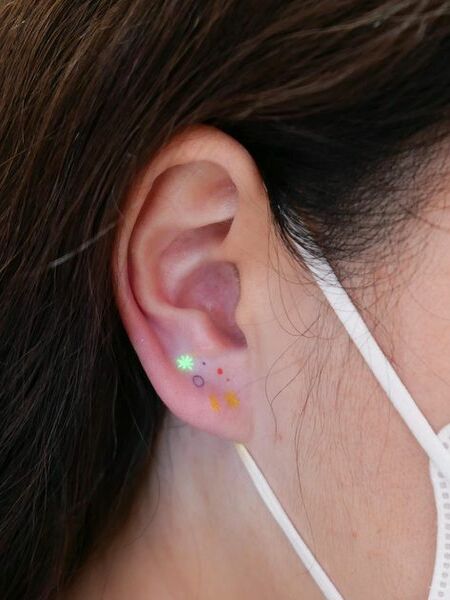 UV Ear Tattoo