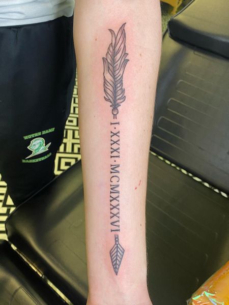 Roman Numeral And Arrow Tattoo