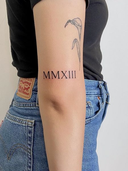 Roman Numeral Arm Tattoo