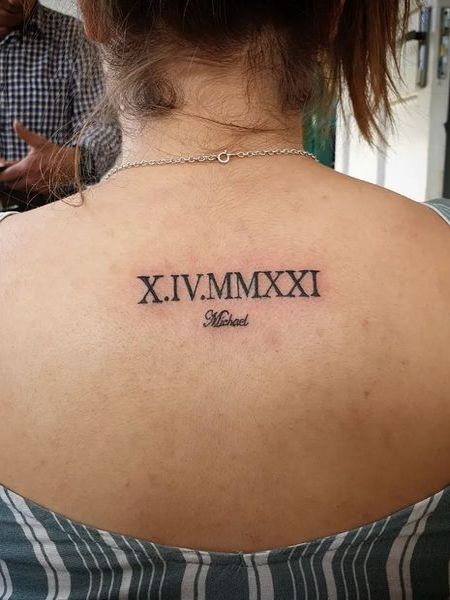 Roman Numeral Back Tattoo