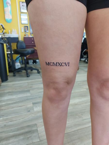 Roman Numeral Leg Tattoo