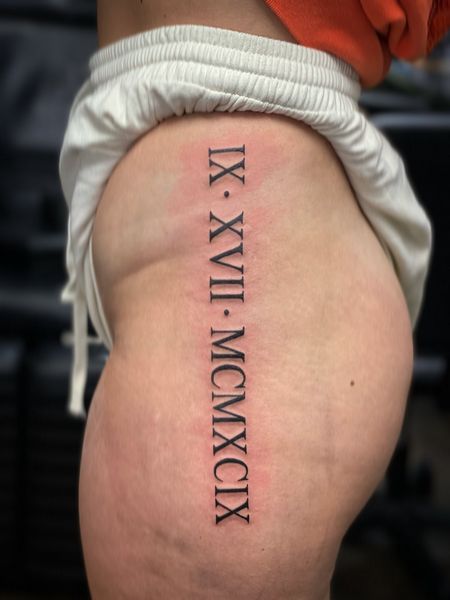 Roman Numeral Thigh Tattoo