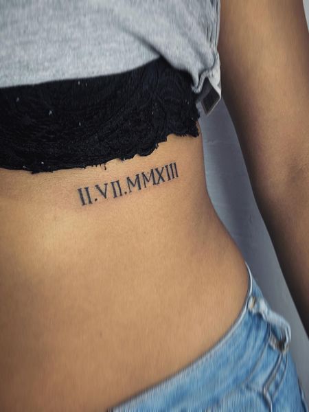 Roman numeral rib tattoo