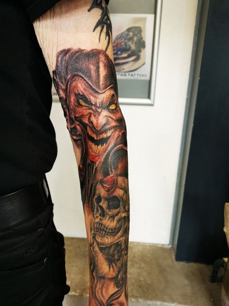 skull and joker tattoo