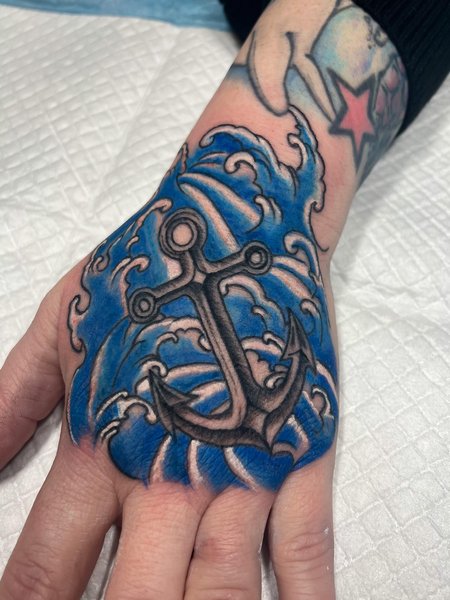 Anchor And Wave Hand Tattoo