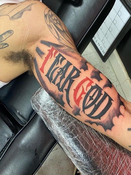 Fear God Bicep Tattoo