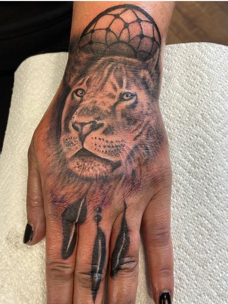 Lioness Hand Tattoo